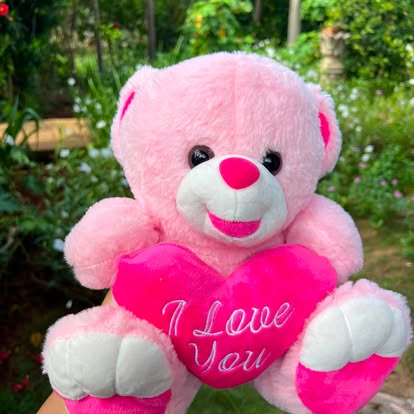 Osito rosa con un corazón y mensaje I Love You.